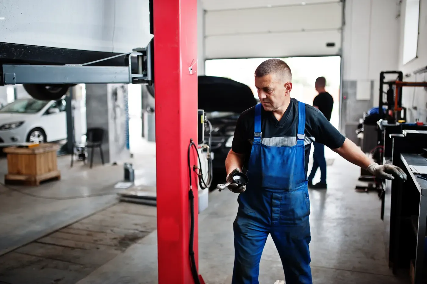 Mechanic servicing a vehicle in an auto repair shop