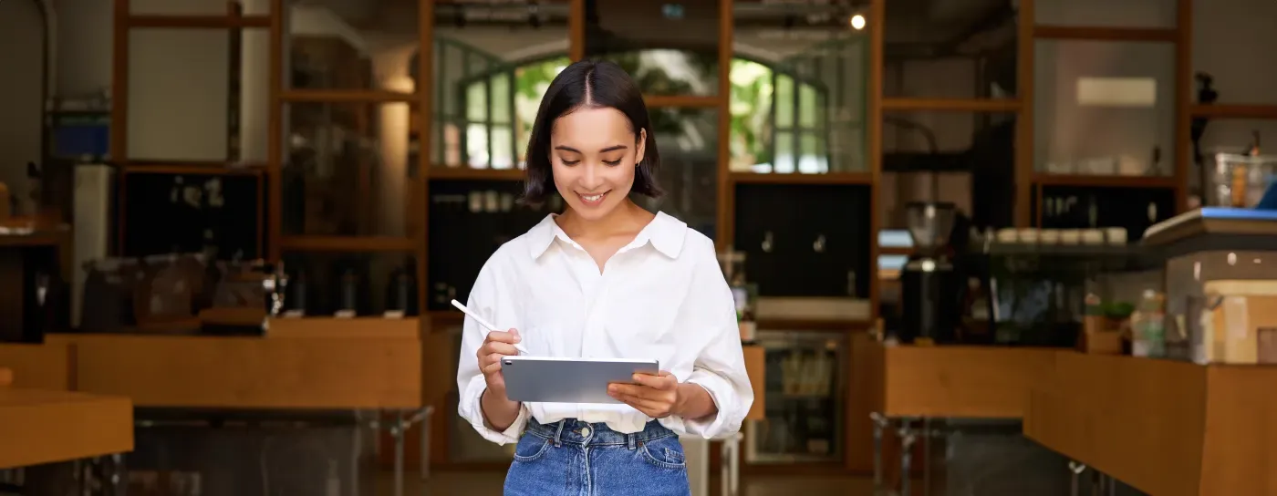 Happy small business owner checking her full appointment schedule