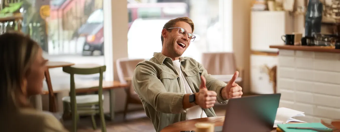 Happy online coach giving a lesson to a client, thumbs up