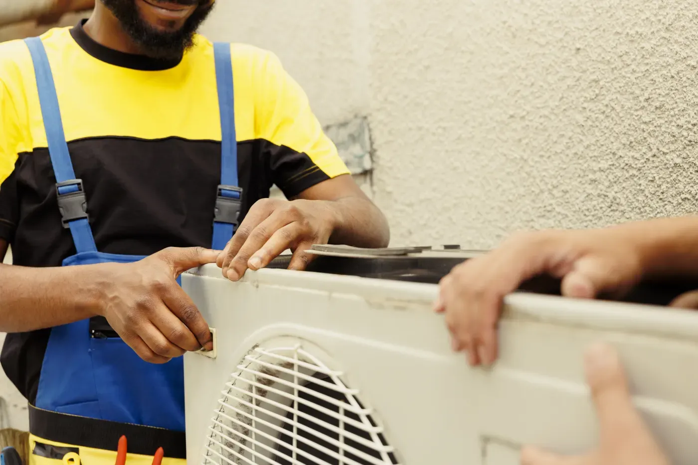 HVAC technician servicing an outdoor air conditioning unit