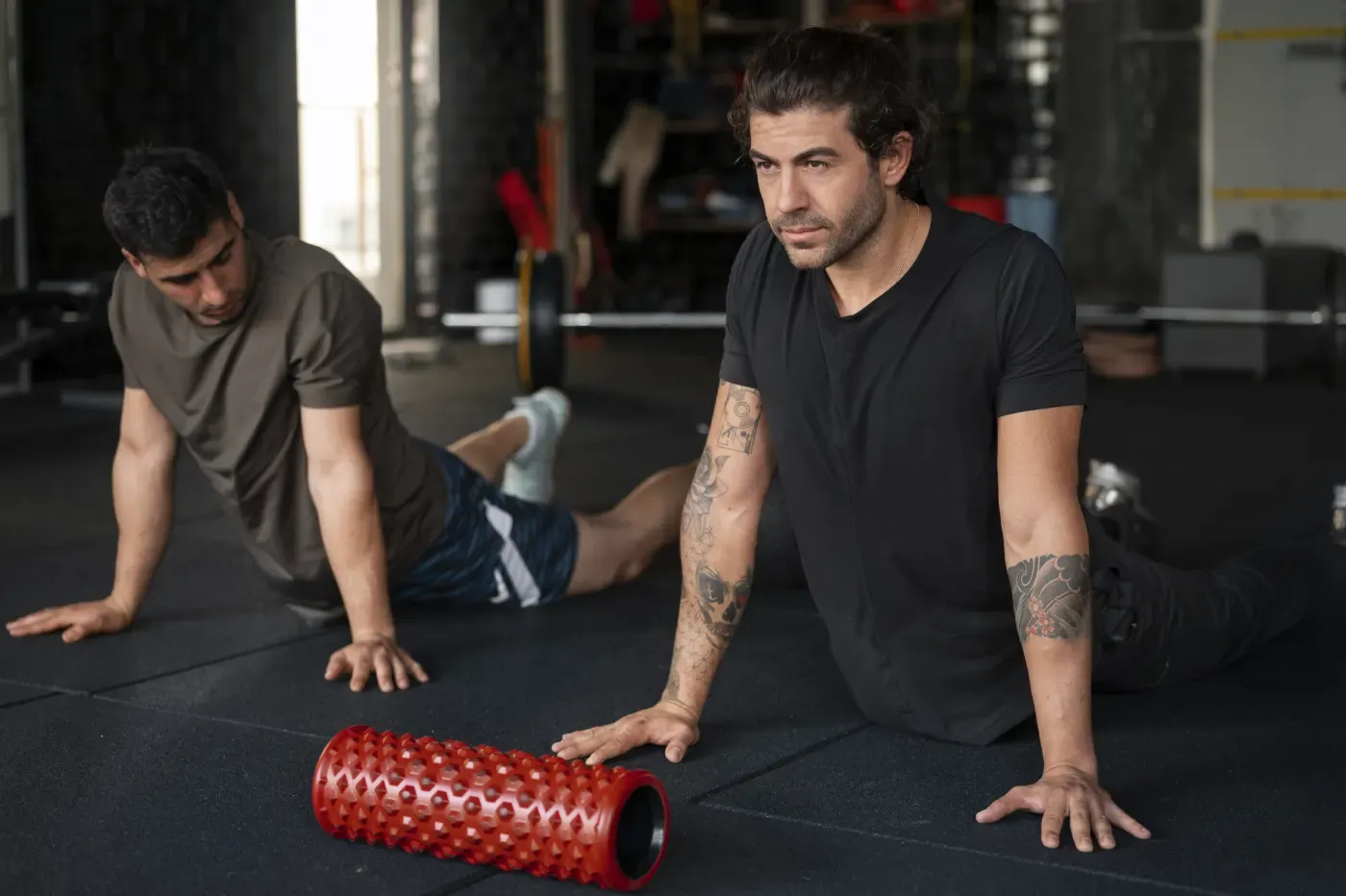 Two clients doing a mobility and stretching session at a gym