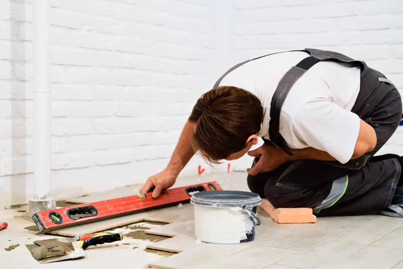 Contractor installing tile during a home renovation project